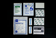MINOR INCIDENT FIELD KIT components, bandages and dressings on a black background